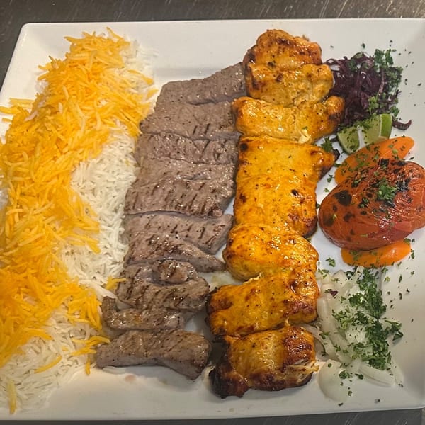 Parisa Persian Grill's platter with saffron rice, grilled beef, chicken kebabs, and roasted vegetables.