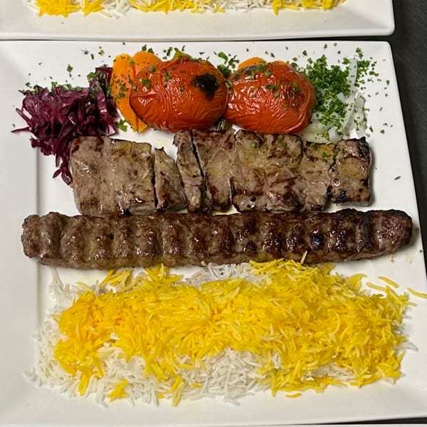 Parisa Persian Grill's koobideh and barg kebabs with grilled tomatoes, red cabbage, and saffron rice.